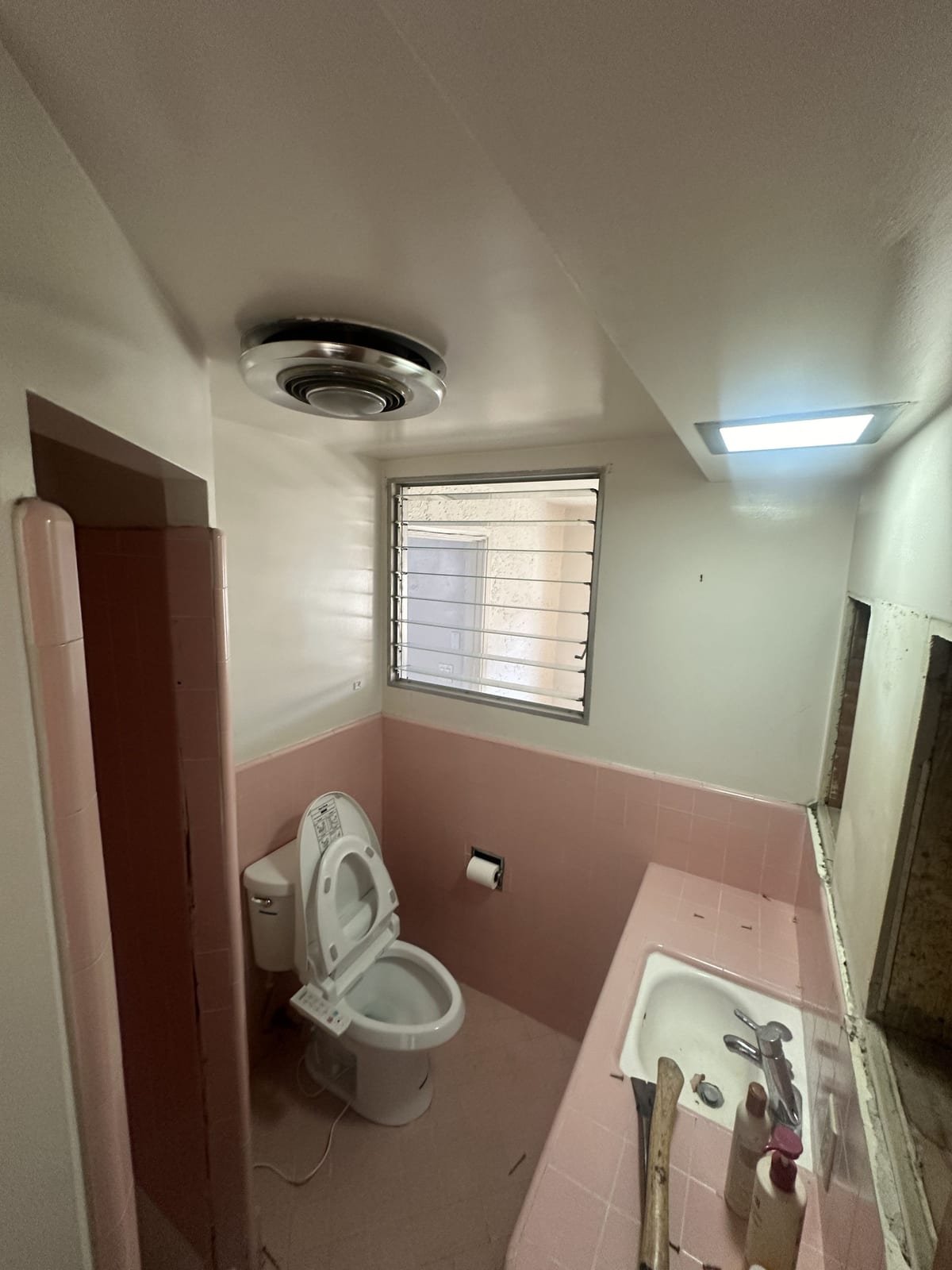 Bathroom before, with original pink tile