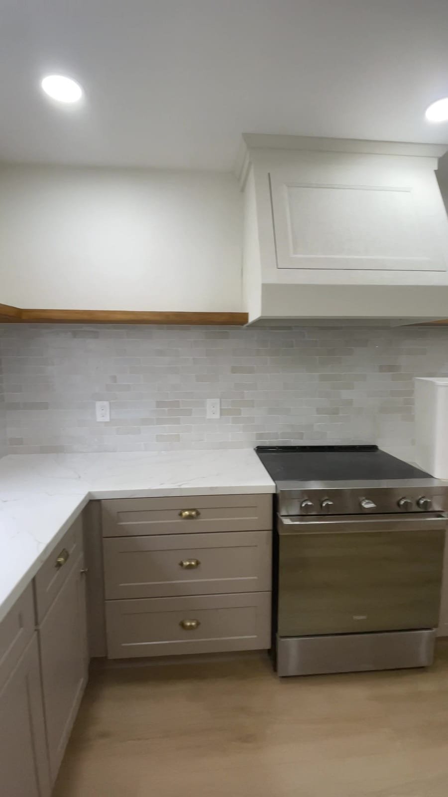 Finished range wall with custom hood