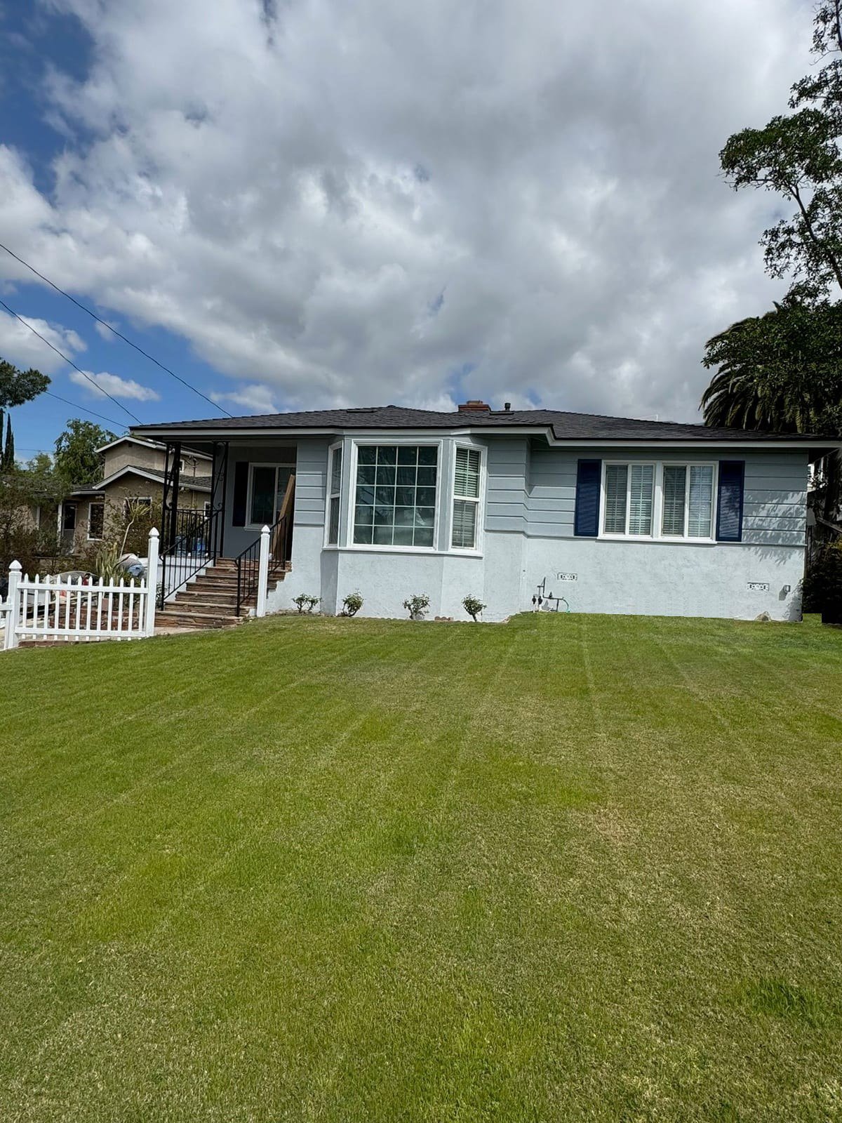 Finished home after a whole-home remodel, with fresh blue-gray exterior paint